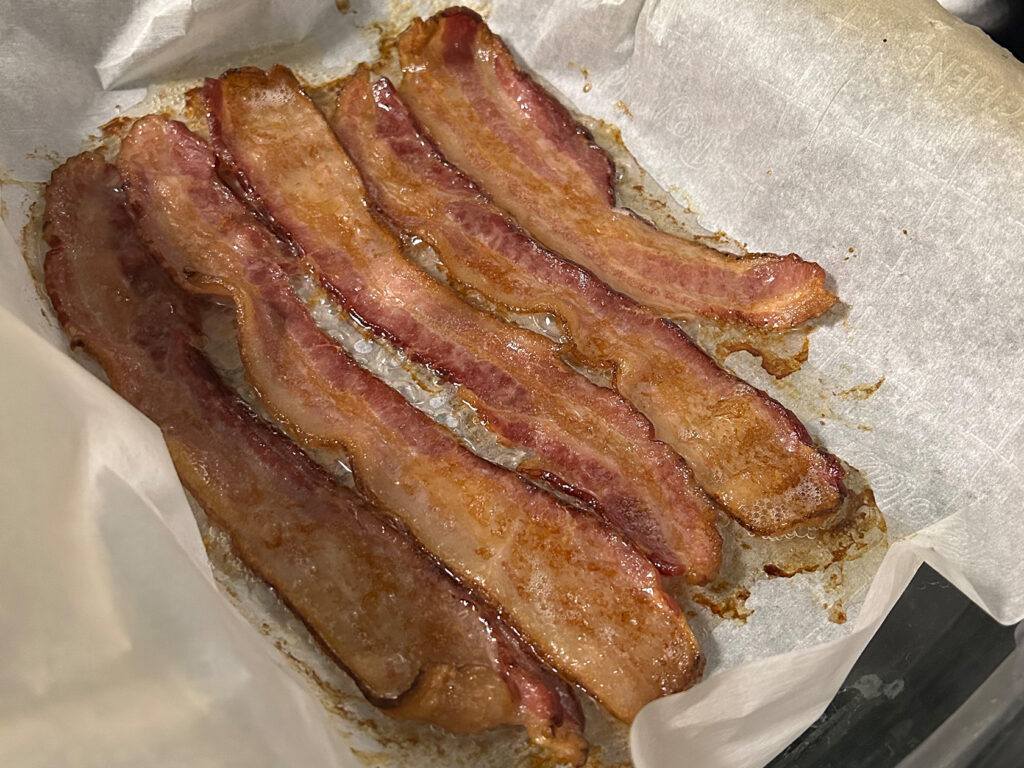 bacon cooked in the oven with parchment paper.